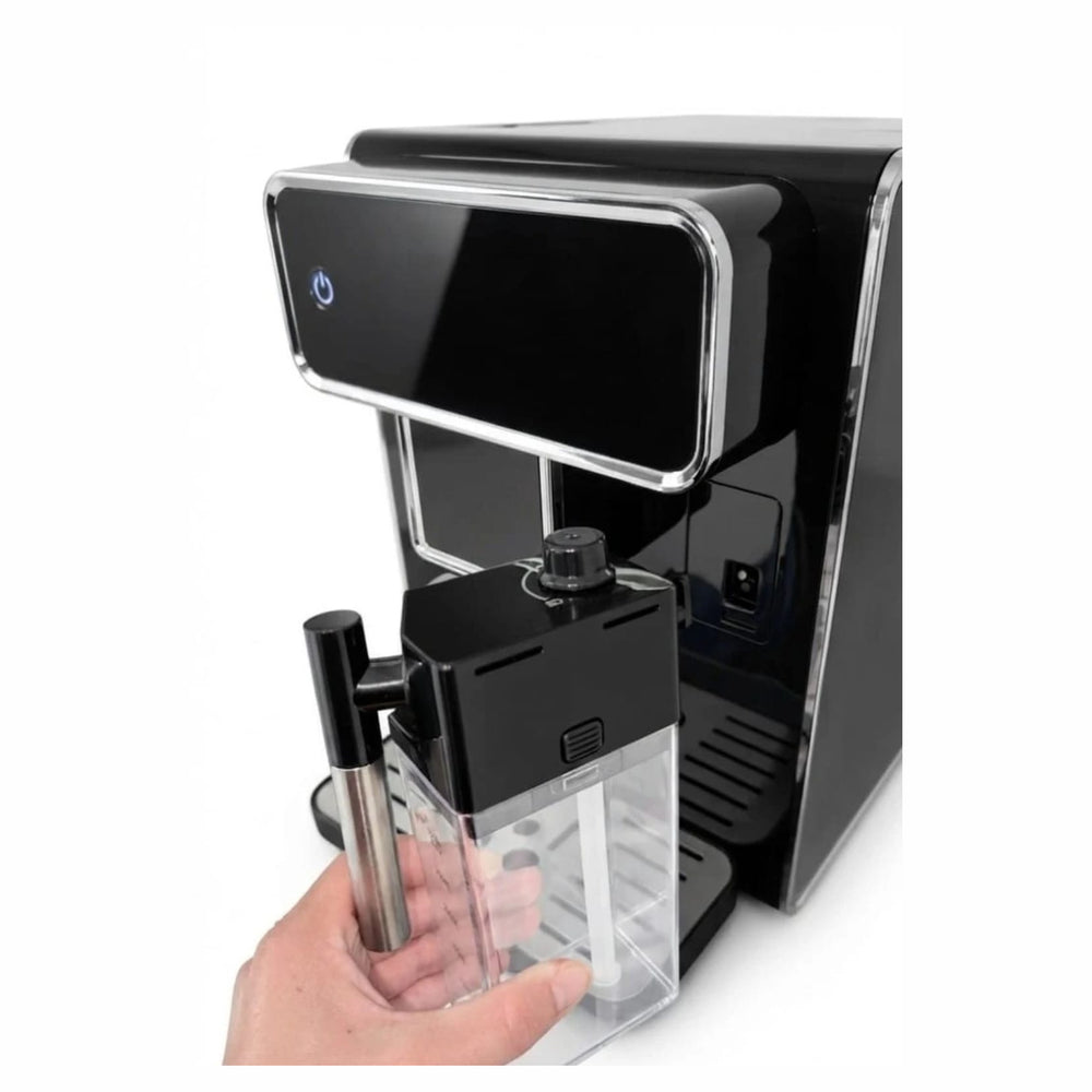 Detachable milk carafe being lifted off the Williams Co. espresso machine
